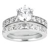 A silver engagement ring with a large central diamond surrounded by smaller diamonds on two bands.