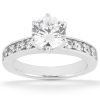 A silver engagement ring with a large round diamond center stone and smaller diamonds set along the band.