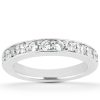 A silver ring with a row of round, clear gemstones embedded along its surface.