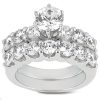A shiny silver ring adorned with a central large diamond and multiple smaller diamonds surrounding it.