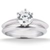 A silver engagement ring set features a round gemstone prominently positioned at the center.