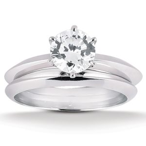 A silver engagement ring set features a round gemstone prominently positioned at the center.