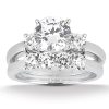 A diamond engagement ring featuring a large central stone surrounded by smaller stones on a silver band.
