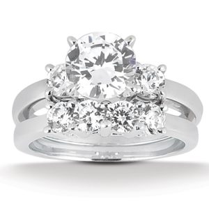 A diamond engagement ring featuring a large central stone surrounded by smaller stones on a silver band.