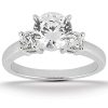 A silver engagement ring features a large central diamond flanked by two smaller diamonds.