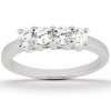 A silver ring with three round, clear gemstones set in a row.