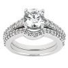 A diamond engagement ring with a large central stone and smaller accent stones on a silver band is displayed against a white background.