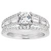 A silver engagement ring features a large round diamond surrounded by smaller accent diamonds.