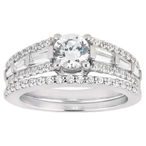 A silver engagement ring features a large round diamond surrounded by smaller accent diamonds.