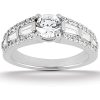 A silver ring features a large central round gemstone surrounded by smaller rectangular and round stones.