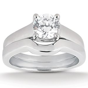 A diamond engagement ring with a round center stone and a sleek, polished band.