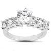 Diamond ring featuring a central round stone with smaller stones set along the band.