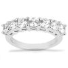 A silver ring showcases a line of five round, clear gemstones arranged in a curved setting.