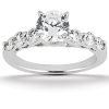 A silver ring features a large central diamond surrounded by smaller diamonds on each side.