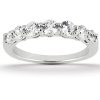 A silver ring featuring a row of sparkling round diamonds.