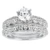 A silver engagement ring featuring a large central diamond surrounded by smaller diamonds in an intricate design.