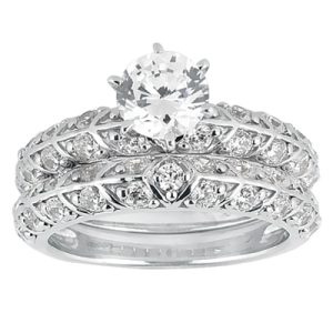 A silver engagement ring featuring a large central diamond surrounded by smaller diamonds in an intricate design.
