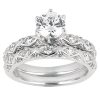 A silver engagement ring with a large central round diamond and smaller diamonds set in an intricate band design.