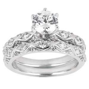 A silver engagement ring with a large central round diamond and smaller diamonds set in an intricate band design.