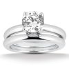 A silver two-piece engagement ring set featuring a round, sparkling diamond as the central stone.