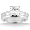 A diamond engagement ring with a princess-cut center stone set in a silver band.