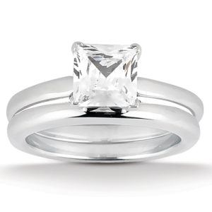A diamond engagement ring with a princess-cut center stone set in a silver band.