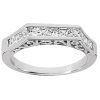 A silver ring featuring a row of clear, princess-cut gemstones set in a stepped design.