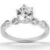 A silver engagement ring features a large central diamond with smaller stones set along the band.