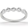 A silver ring with five equally spaced clear gemstones set in a row.