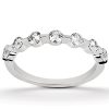 A silver ring featuring a series of round gemstones arranged in a continuous pattern.