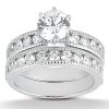 A silver engagement ring with a large central diamond and smaller diamonds set along the bands.