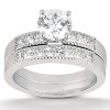 A diamond engagement ring with a round center stone and multiple smaller stones set in a silver band.