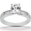 A silver engagement ring features a large, round, clear central stone with smaller accent stones set on either side.