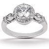 A diamond engagement ring with a round central stone and smaller surrounding stones on a silver band is displayed.