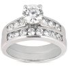 A silver wedding ring set features a central round diamond surrounded by smaller diamonds on two curved bands.