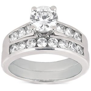 A silver wedding ring set features a central round diamond surrounded by smaller diamonds on two curved bands.