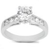 A silver engagement ring features a large central clear diamond and smaller diamonds set along the band.