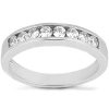 A silver ring features a row of small round gemstones set along its band.
