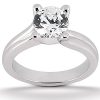 A silver engagement ring features a prominent round diamond centerpiece.
