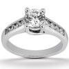 A silver engagement ring features a large round diamond at the center and smaller diamonds set along the band.
