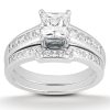 A diamond engagement ring with a princess-cut center stone and a band featuring smaller, channel-set diamonds.