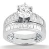 A silver engagement ring with a large round center diamond and smaller baguette cut diamonds set along the band.