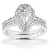 A teardrop-shaped diamond ring is displayed, featuring a central large diamond surrounded by smaller diamonds on the band.