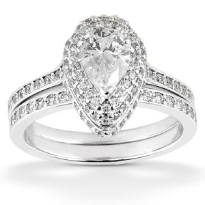 A teardrop-shaped diamond ring is displayed, featuring a central large diamond surrounded by smaller diamonds on the band.