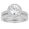 A silver engagement ring features a large round diamond surrounded by smaller accent stones on a textured band.