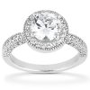 A silver engagement ring features a large round diamond surrounded by smaller accent stones on the band.