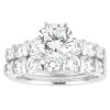 A diamond engagement ring set features a central round-cut diamond surrounded by smaller round diamonds on a polished white metal band.
