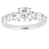 A silver ring features a large round diamond in the center and smaller diamonds on either side.