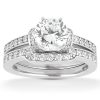 A silver engagement ring set features a large round diamond center stone surrounded by smaller diamonds on the band.