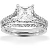 A silver engagement ring features a large square-cut center stone with smaller round stones along the band.